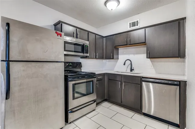 a kitchen with a refrigerator sink and microwave