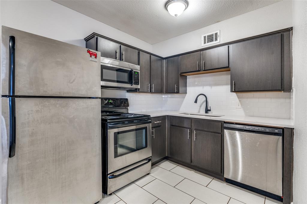 4618 Reiger Avenue, Unit 101 Dallas, TX 75246 - Photo 7 of 17 a kitchen with a refrigerator sink and microwave