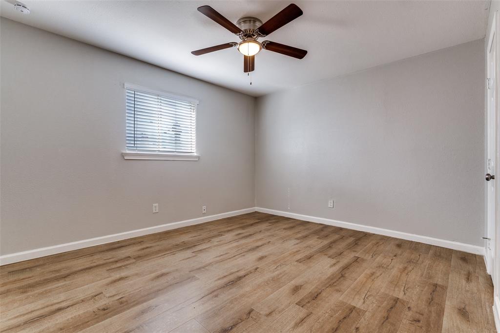 4618 Reiger Avenue, Unit 101 Dallas, TX 75246 - Photo 9 of 17 wooden floor in an empty room with a window