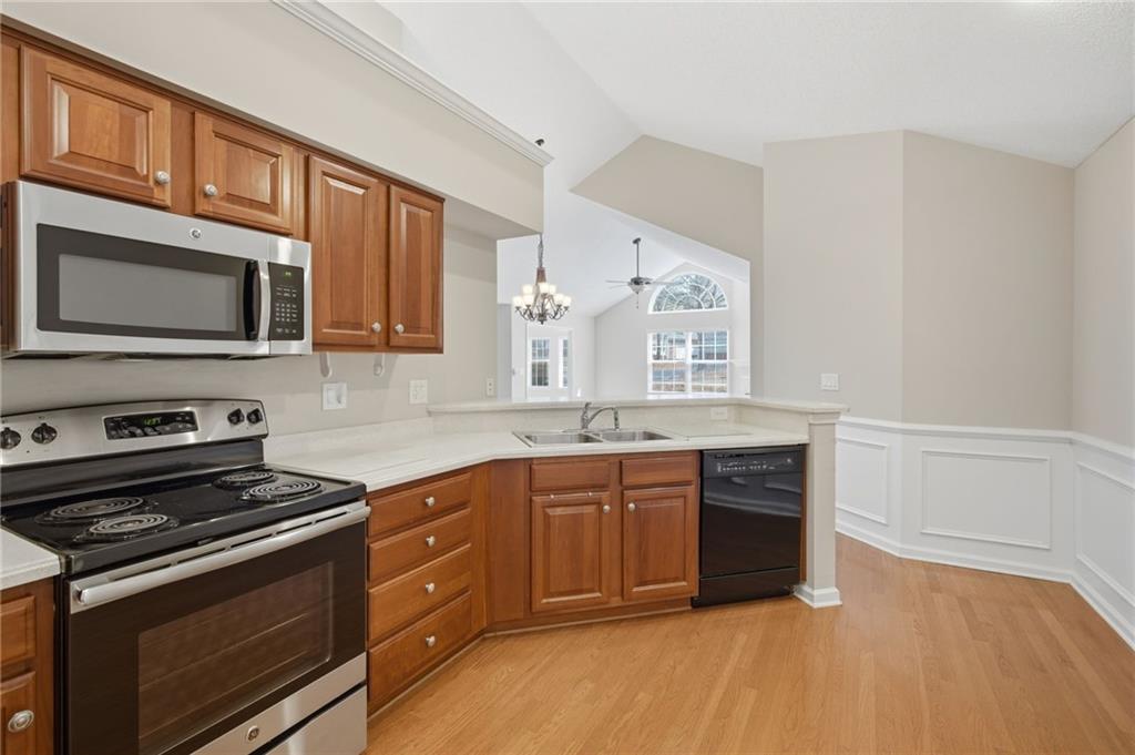 2994 Oakside Circle Alpharetta, GA 30004 - Photo 15 of 32 a kitchen with stainless steel appliances granite countertop a stove microwave and cabinets