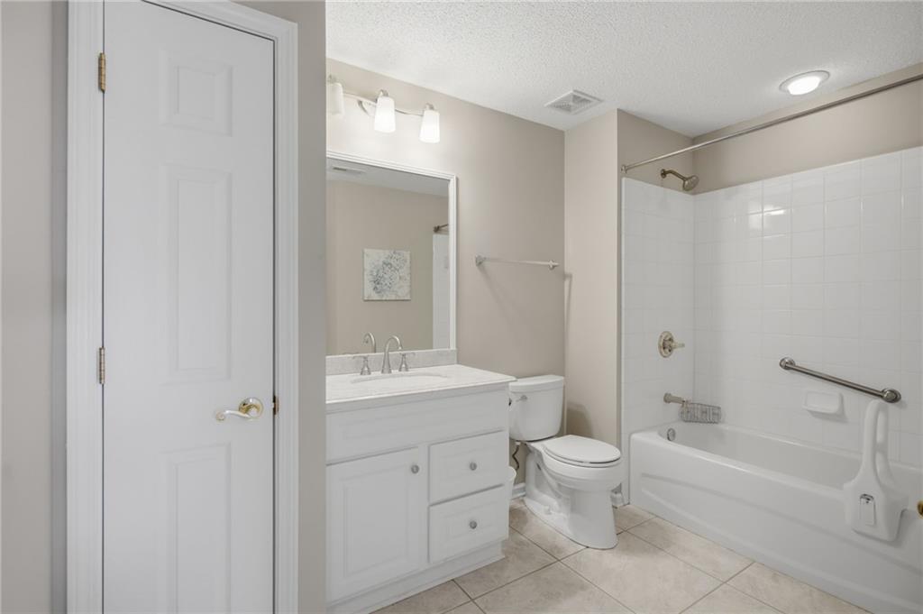 2994 Oakside Circle Alpharetta, GA 30004 - Photo 27 of 32 a bathroom with a toilet a bath tub a sink and a mirror