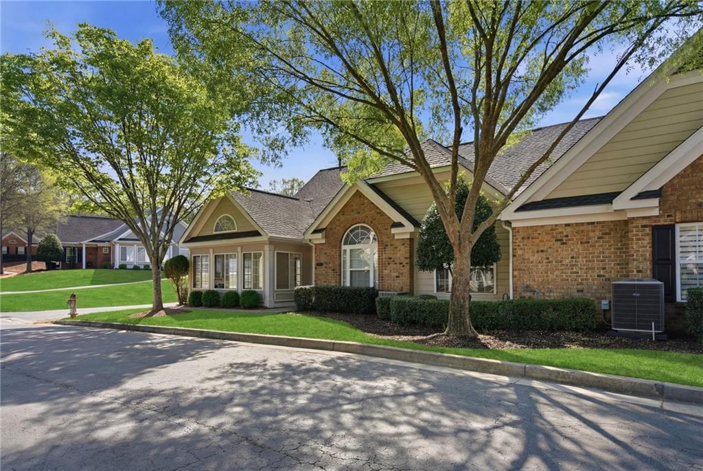 2994 Oakside Circle Alpharetta, GA 30004 - Photo 6 of 32 a front view of a house with a yard