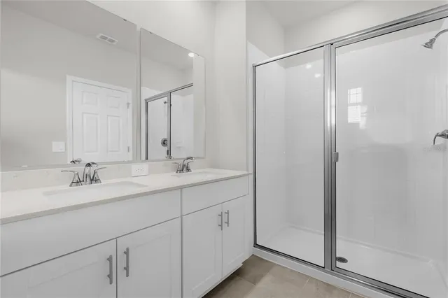 a bathroom with a double vanity sink and mirror