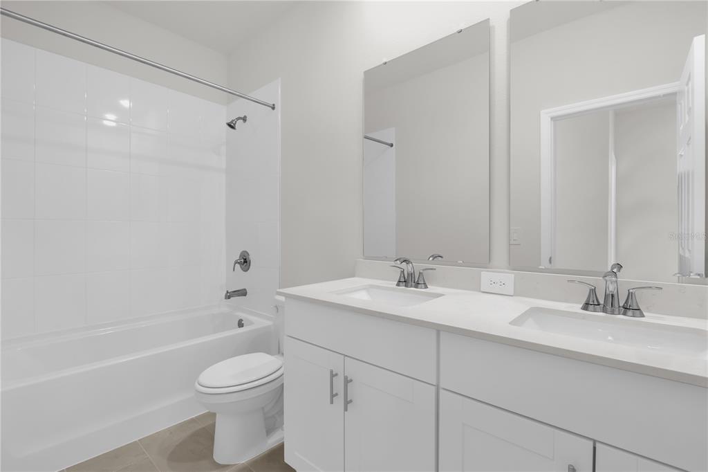 4556 Homestead Trail St. Cloud, FL 34772 - Photo 16 of 31 a bathroom with a toilet a sink a mirror a bathtub and vanity