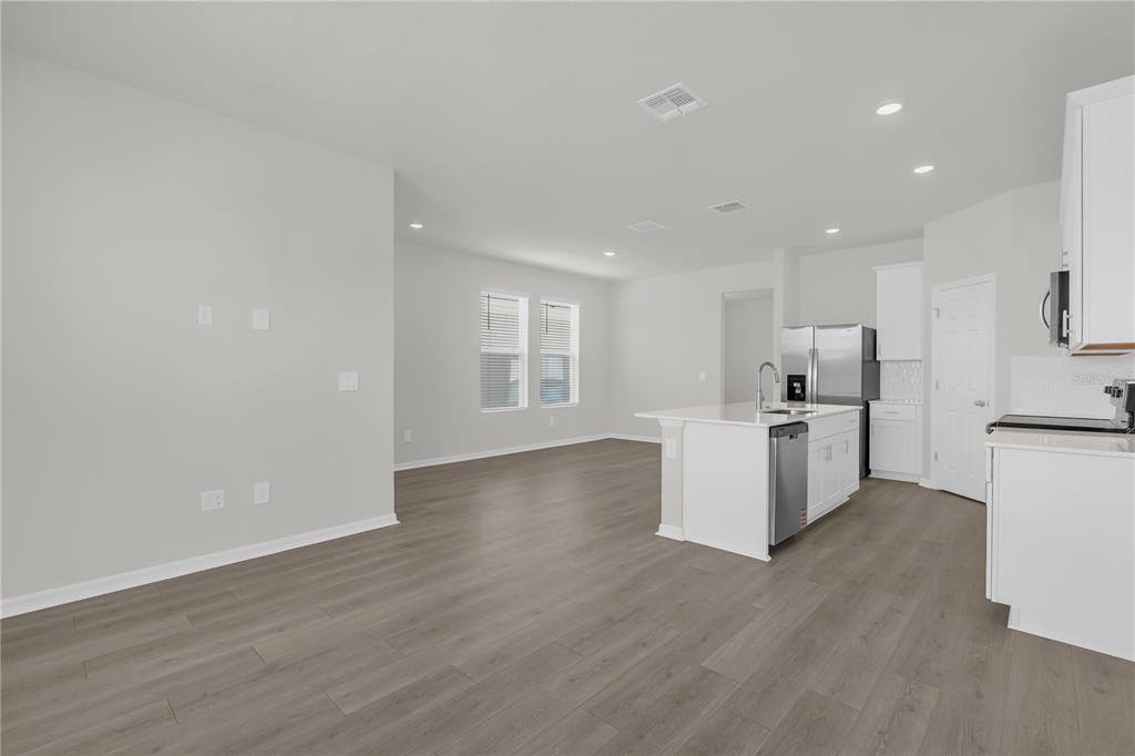 4556 Homestead Trail St. Cloud, FL 34772 - Photo 2 of 31 a view of a kitchen with wooden floor and electronic appliances