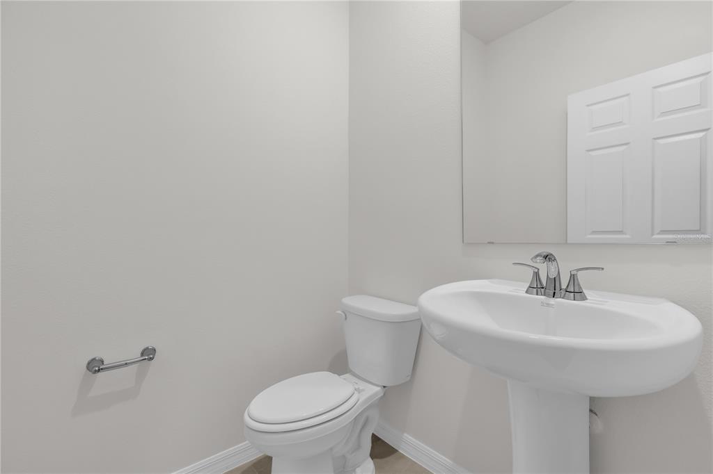4556 Homestead Trail St. Cloud, FL 34772 - Photo 24 of 31 a bathroom with a sink a toilet and a mirror