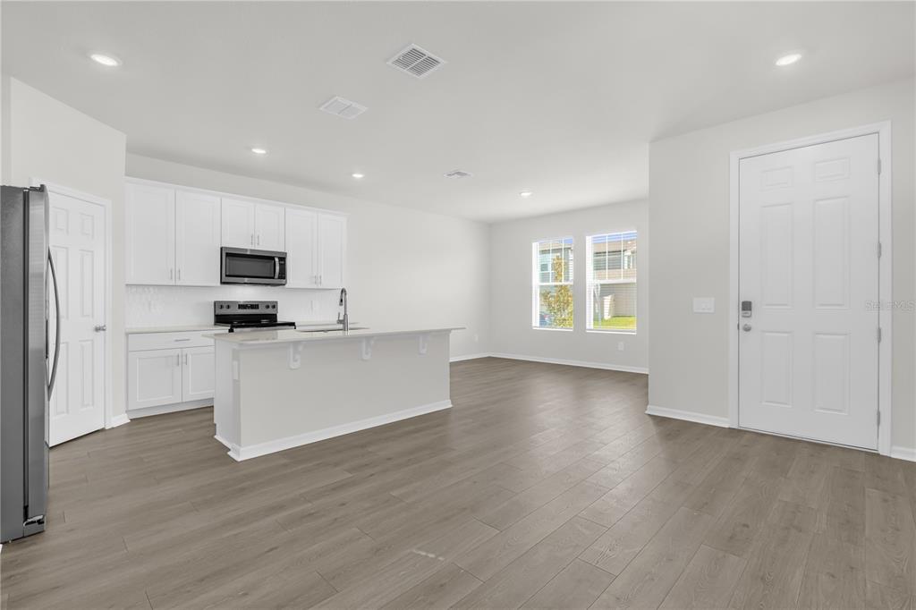 4556 Homestead Trail St. Cloud, FL 34772 - Photo 6 of 31 a view of an empty room with window and wooden floor