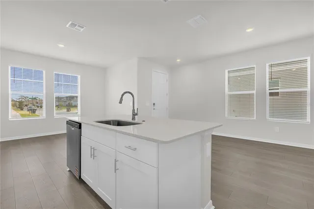 a kitchen with a sink stove and cabinets