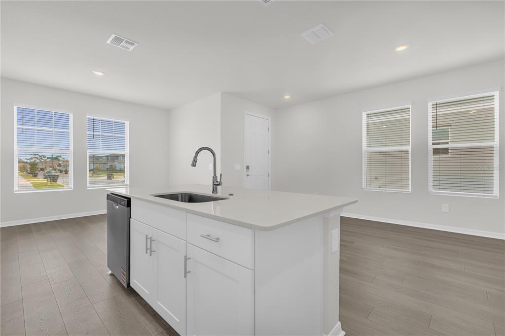 4556 Homestead Trail St. Cloud, FL 34772 - Photo 7 of 31 a kitchen with a sink stove and cabinets