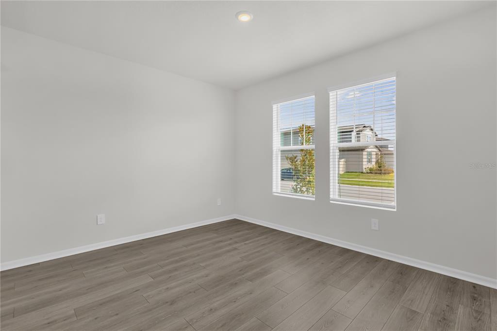 4556 Homestead Trail St. Cloud, FL 34772 - Photo 9 of 31 a view of an empty room with wooden floor and a window