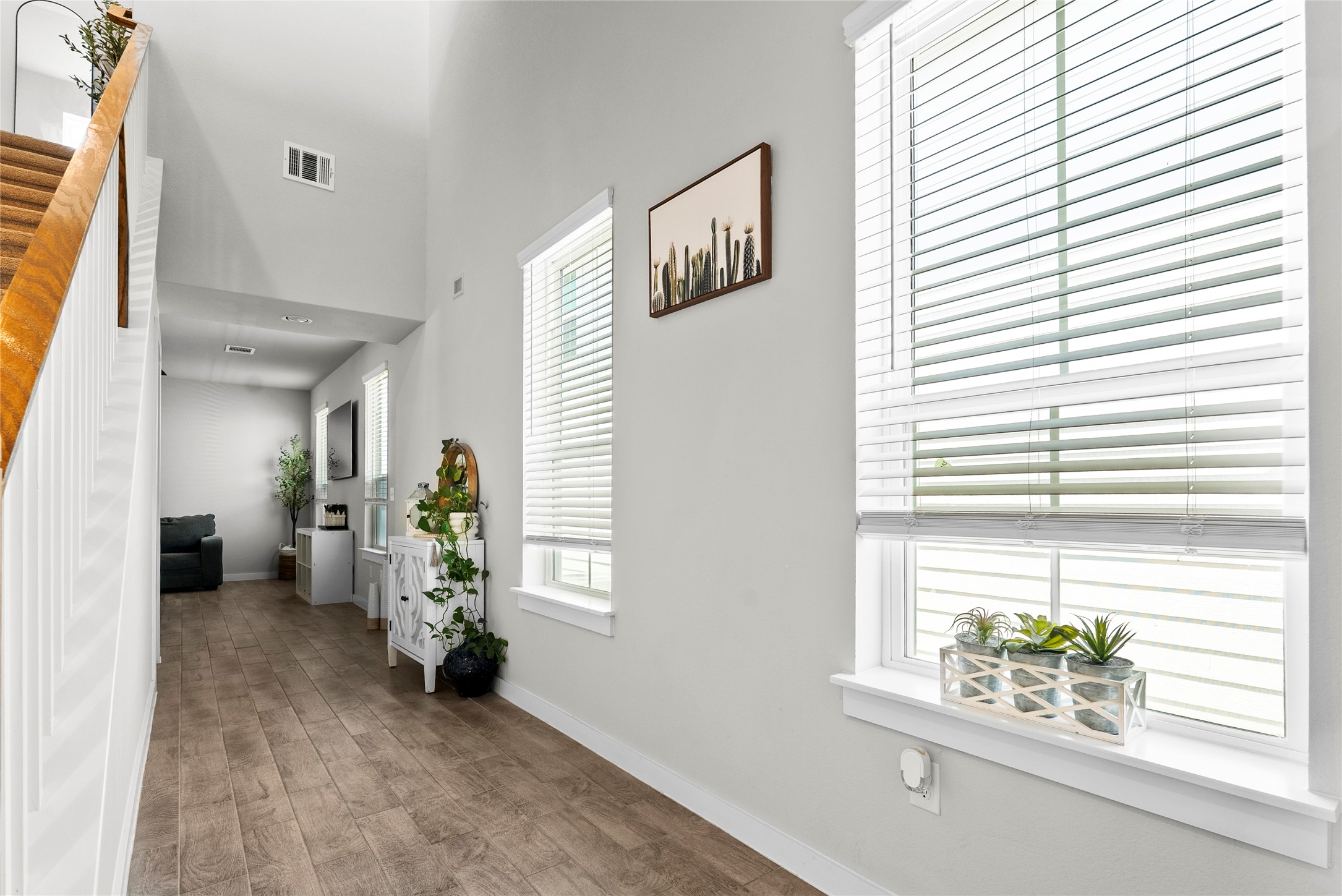 156 Appleberry Lane Elgin, TX 78621 - Photo 11 of 40 Foyer entrance with wood style flooring, towering ceiling, and stairway.