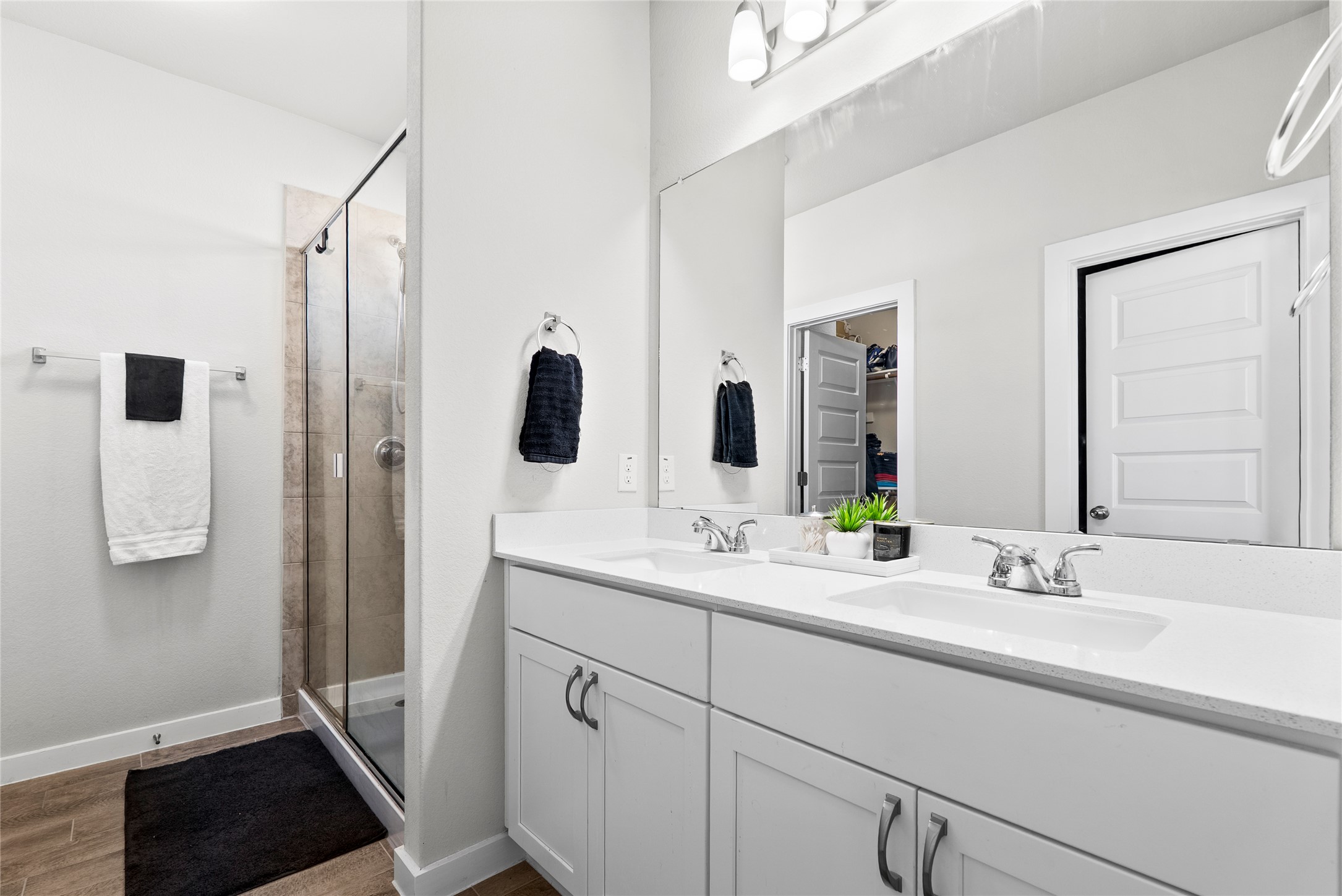 156 Appleberry Lane Elgin, TX 78621 - Photo 15 of 40 Full bath with a shower stall, a spacious closet, double vanity, and wood style floors