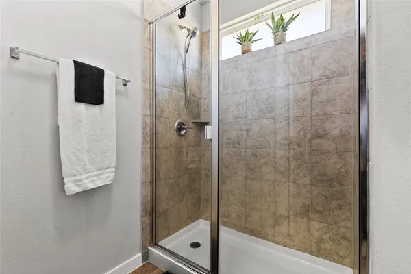 a bathroom with a shower and a sink