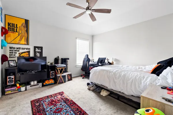 a bed room with a bed a desk and a window
