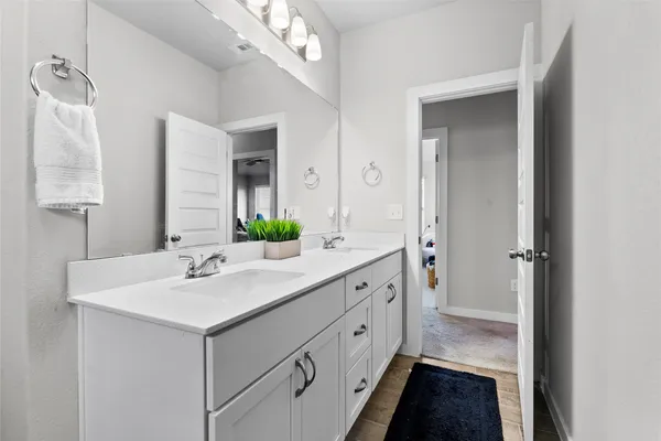 a bathroom with a sink double vanity and a mirror