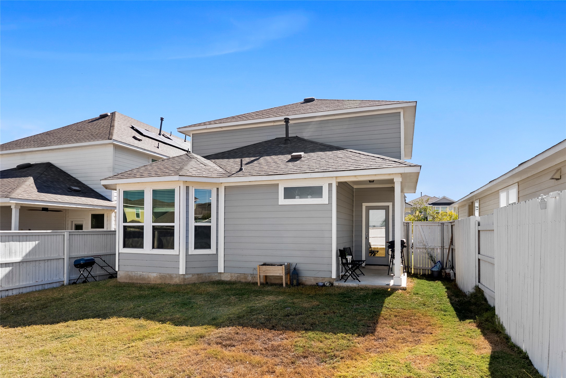 156 Appleberry Lane Elgin, TX 78621 - Photo 26 of 40 Back of house featuring a patio area and a fenced backyard