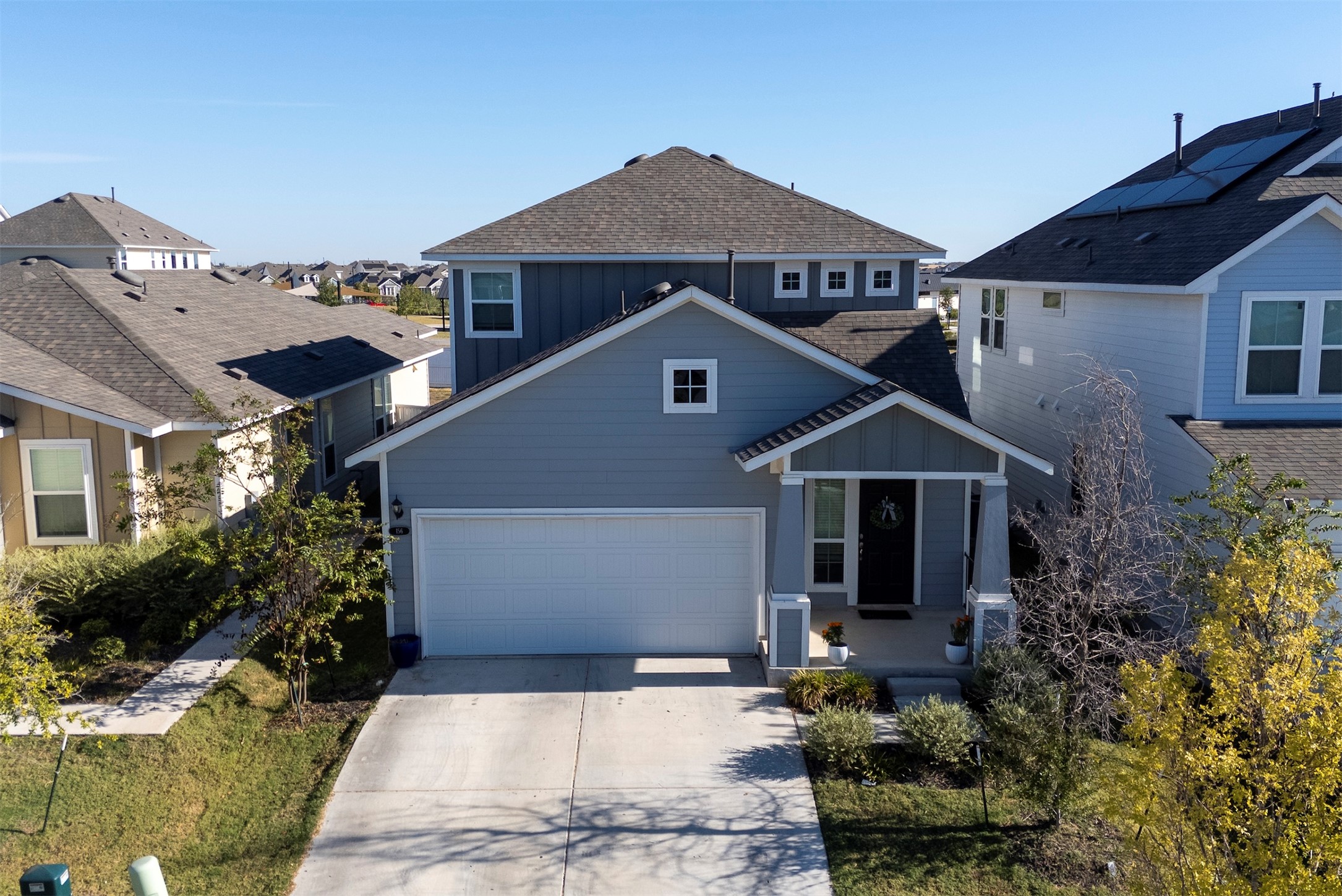 156 Appleberry Lane Elgin, TX 78621 - Photo 3 of 40 View of front of property with board and batten siding, a shingled roof, and driveway