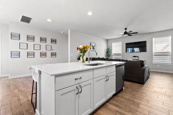 a kitchen with a sink appliances and cabinets