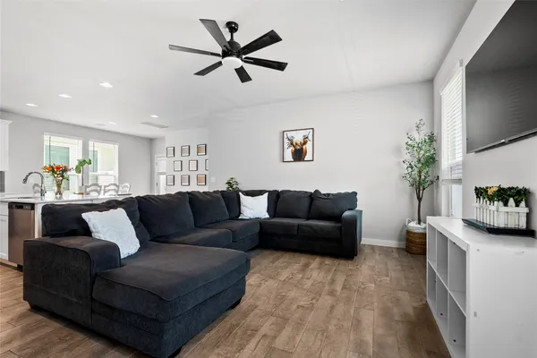 a living room with furniture and a wooden floor