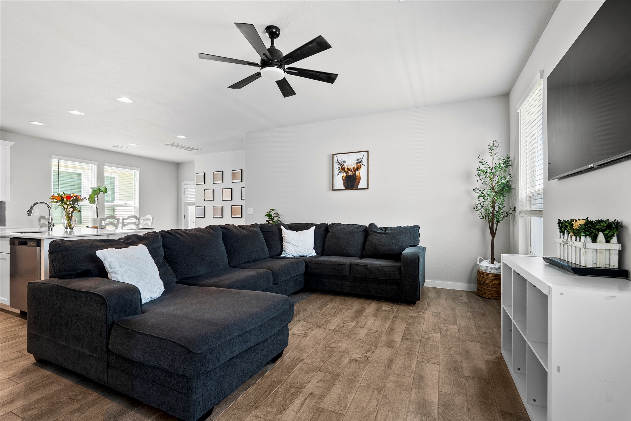 156 Appleberry Lane Elgin, TX 78621 - Photo 9 of 40 Kitchen opens to family room featuring plenty of natural light, recessed lighting, and a ceiling fan