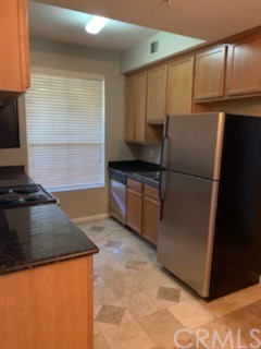 375 Central Avenue, Unit 67 Riverside, CA 92507 - Photo 1 of 1 a kitchen with granite countertop a refrigerator and a stove