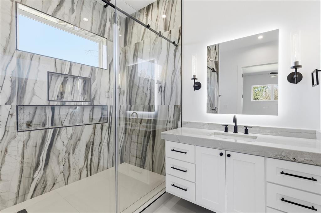 6257 Turner Way Dallas, TX 75230 - Photo 29 of 39 a bathroom with a double vanity sink and mirror