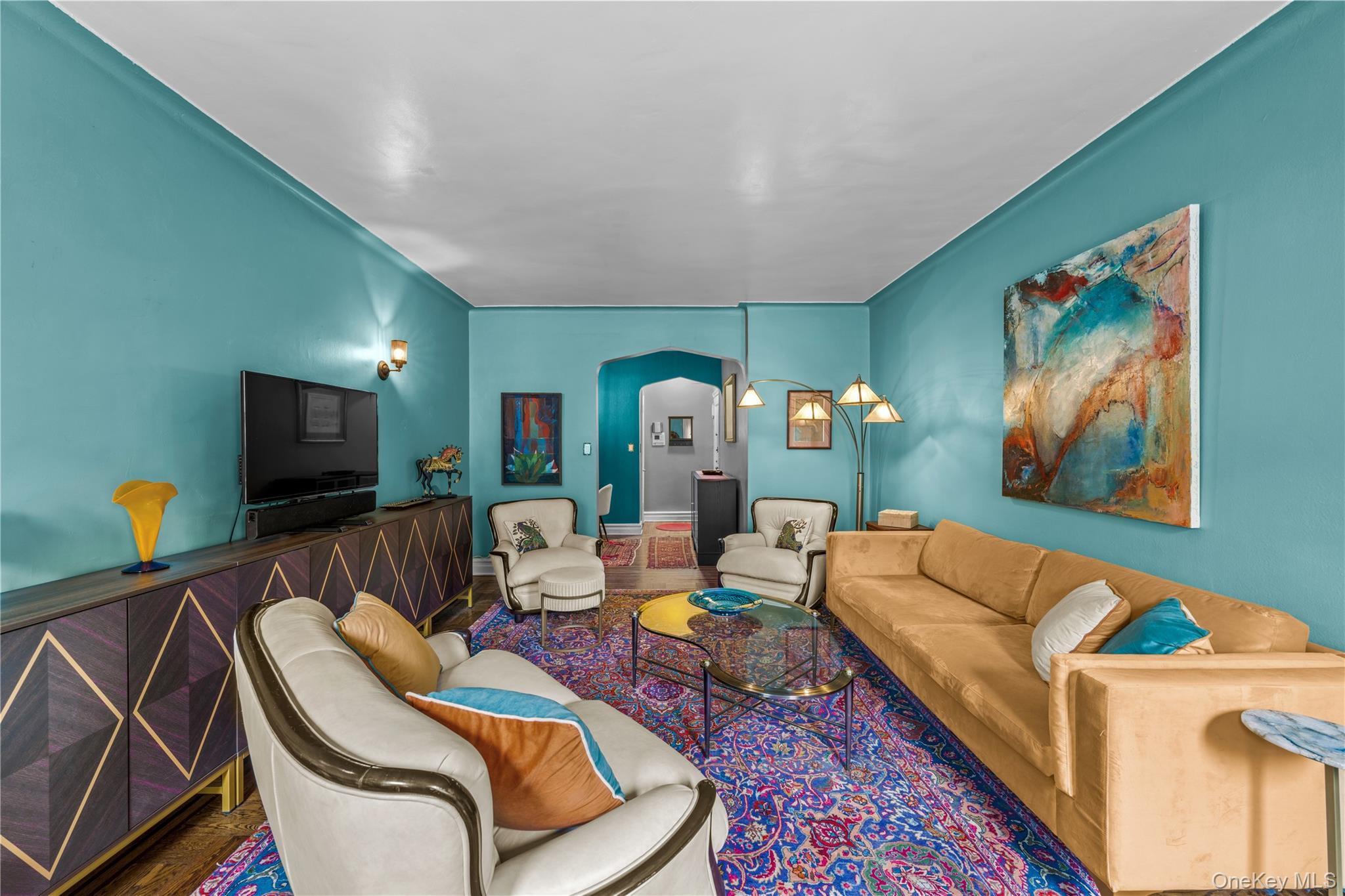 35-05 72nd Street, Unit 2E Queens, NY 11372 - Photo 2 of 14 a living room with furniture and a flat screen tv