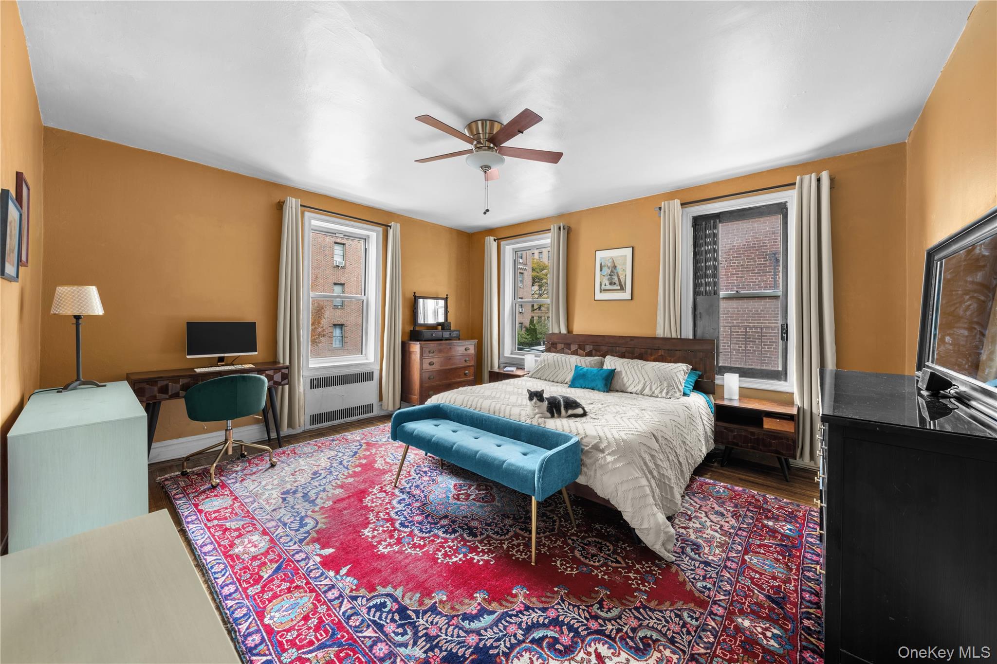 35-05 72nd Street, Unit 2E Queens, NY 11372 - Photo 7 of 14 a bedroom with a bed and wooden floor