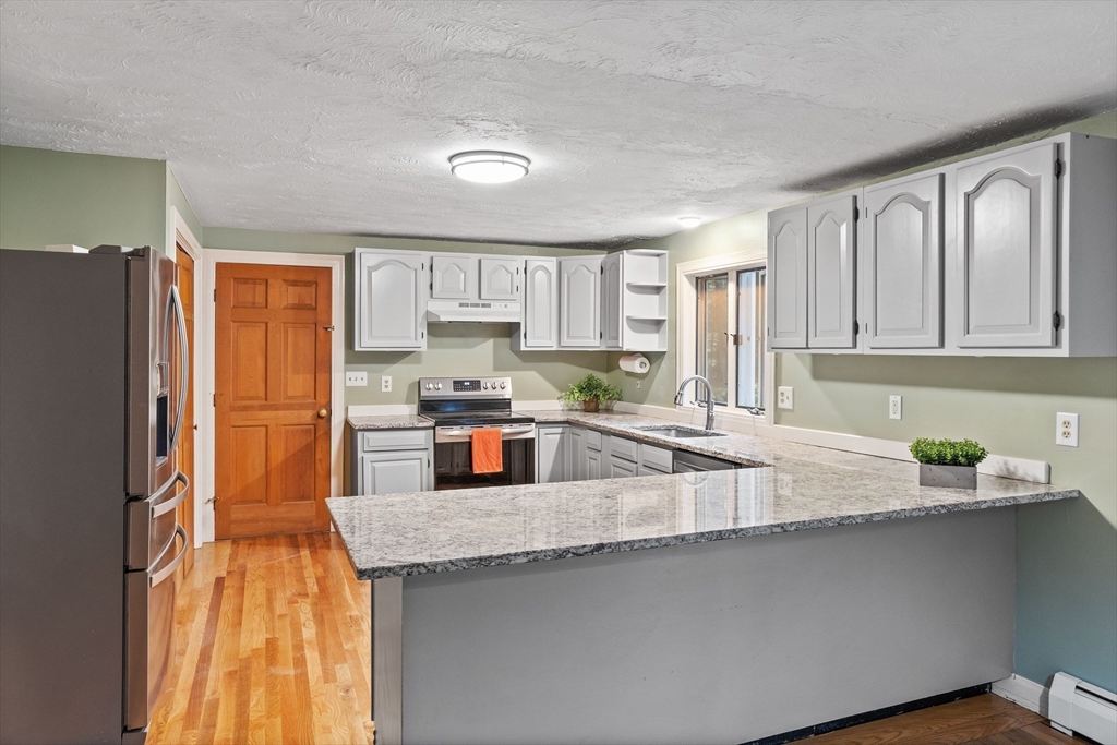 93 Turner Road Townsend, MA 01469 - Photo 11 of 32 a kitchen with counter top space cabinets and stainless steel appliances