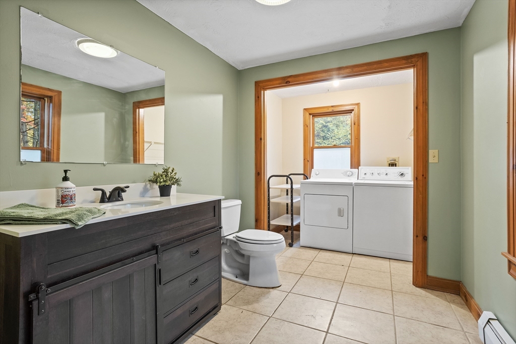 93 Turner Road Townsend, MA 01469 - Photo 15 of 32 a bathroom with a toilet sink and mirror