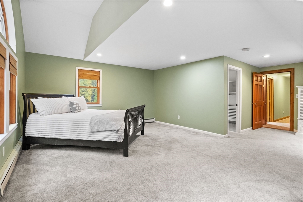 93 Turner Road Townsend, MA 01469 - Photo 24 of 32 a bedroom with a bed and a couch