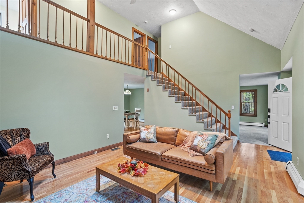 93 Turner Road Townsend, MA 01469 - Photo 3 of 32 a living room with furniture and stairs with wooden floor