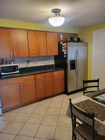 a kitchen with stainless steel appliances a stove a sink and cabinets