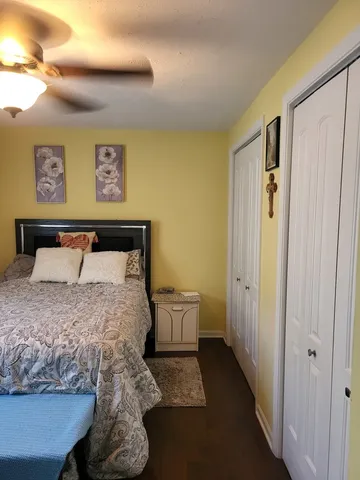 a bedroom with a bed and painting on the wall