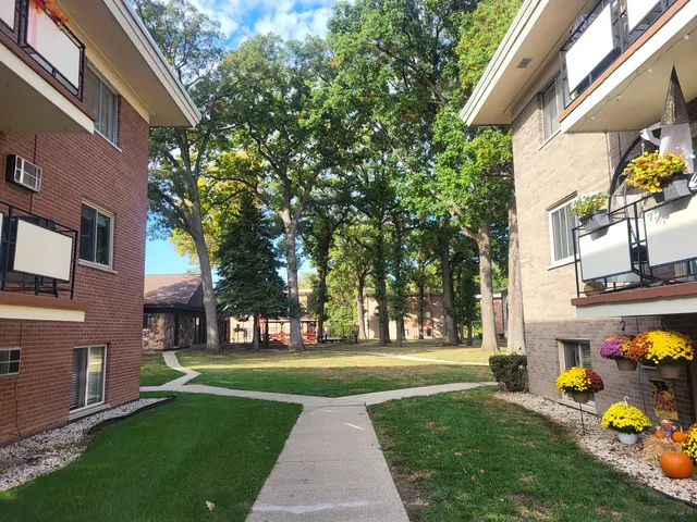 a front view of a building with a garden