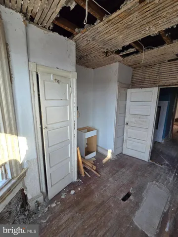 a view of a room with wooden floor