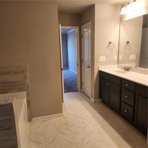 a spacious bathroom with a double vanity sink and a mirror