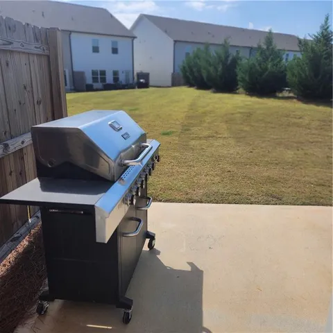 a view of swimming pool with seating area and trees in the background