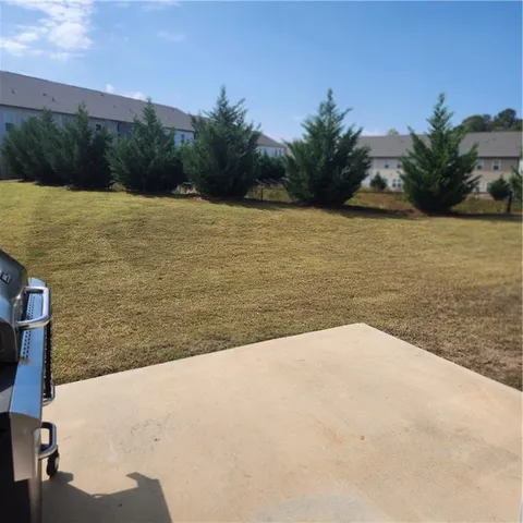 a view of swimming pool with a lounge chairs