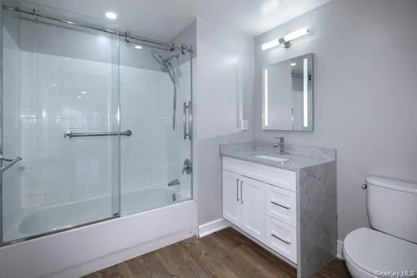 a bathroom with a sink a toilet and shower