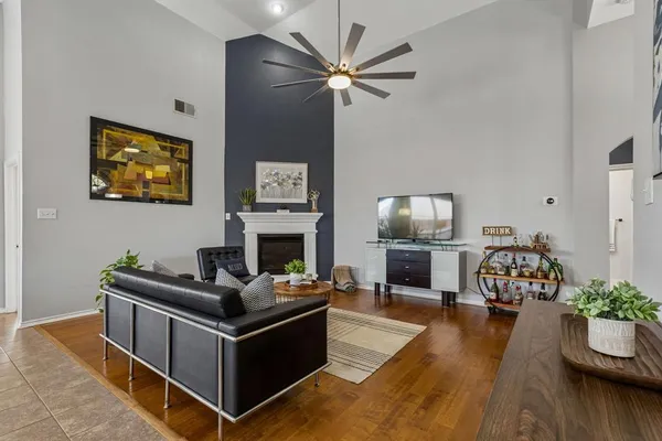a living room with furniture fireplace and wooden floor