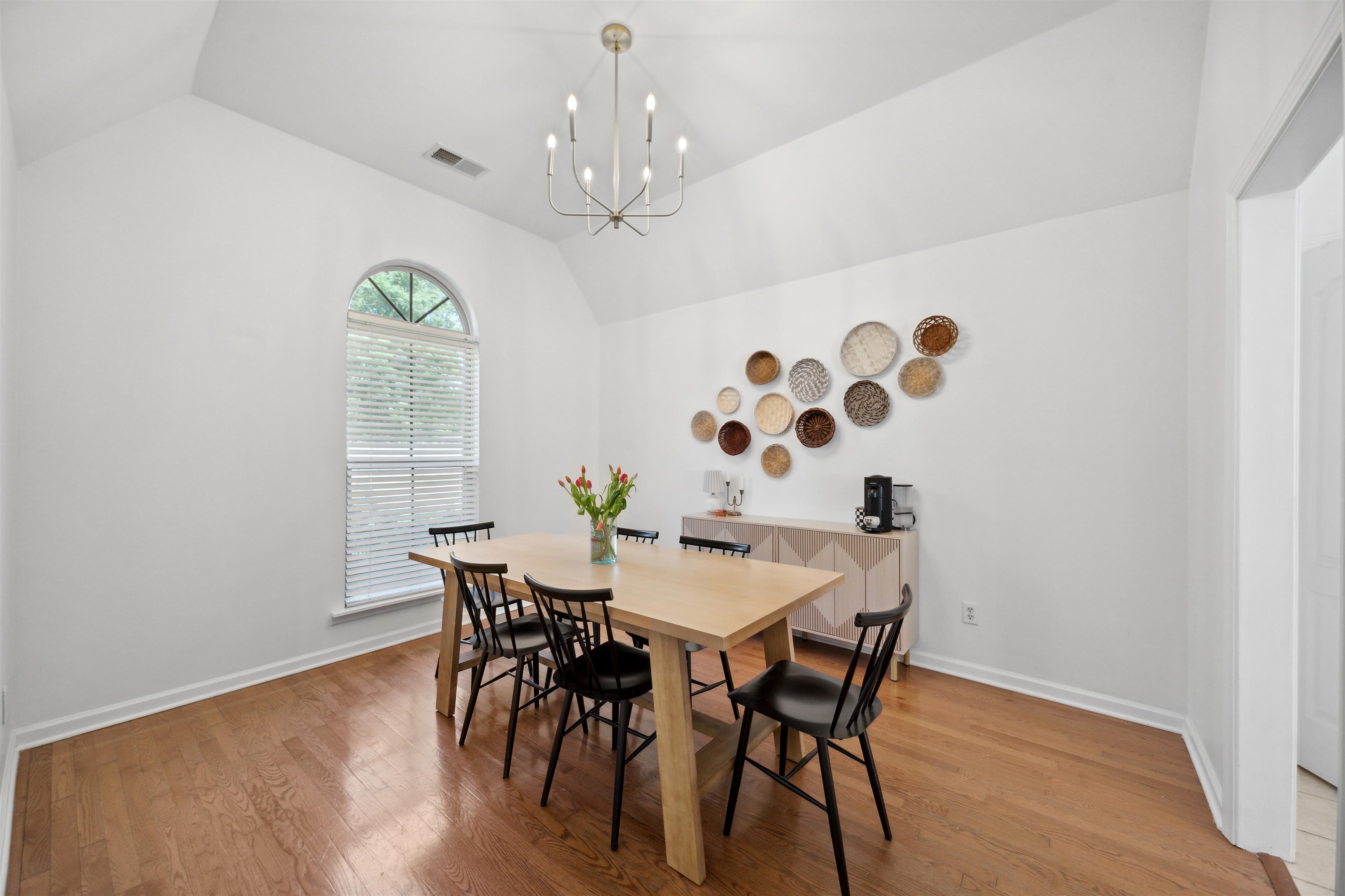 a view of a dining room with furniture and chandelier