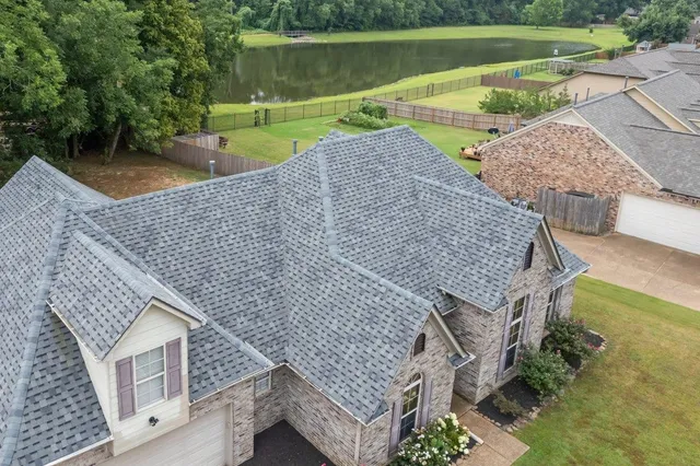 an aerial view of a house with a yard basket ball court and outdoor seating