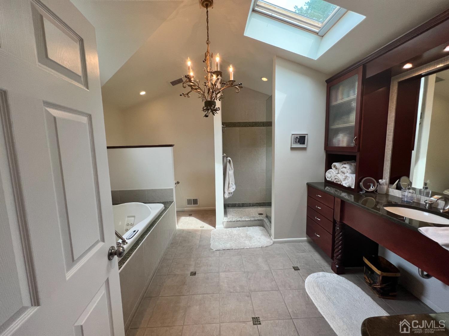 55 Winton Road East Brunswick, NJ 08816 - Photo 17 of 39 a spacious bathroom with a double vanity sink a large mirror and shower