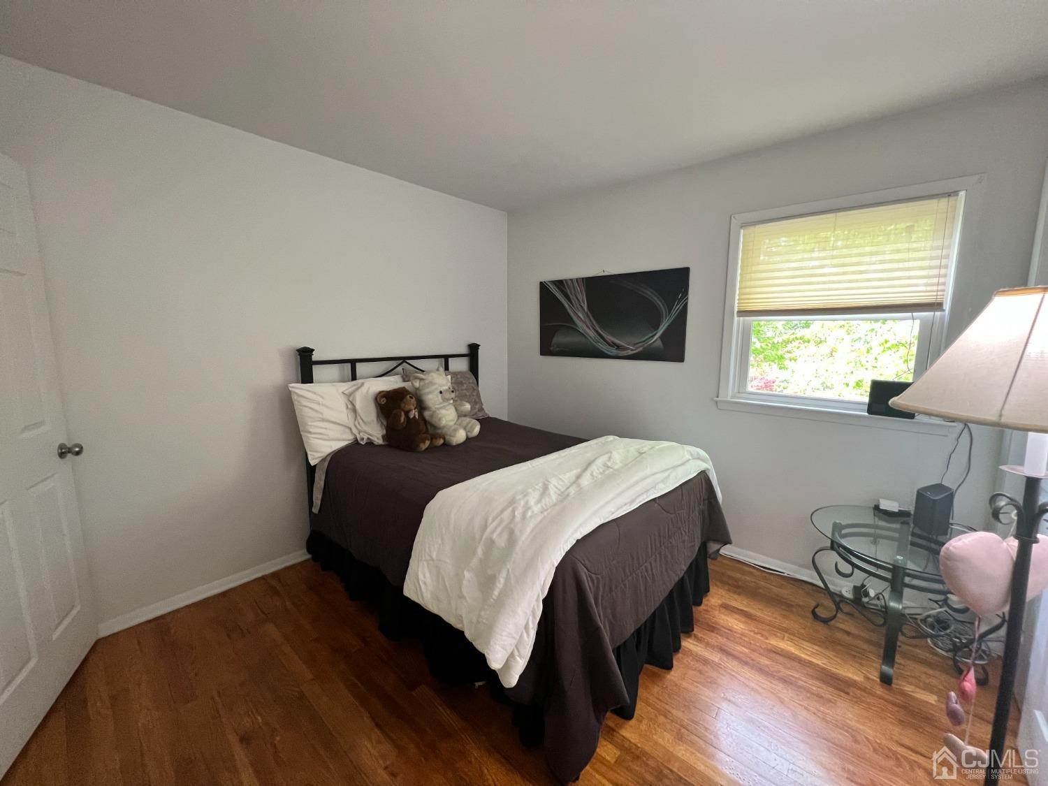 55 Winton Road East Brunswick, NJ 08816 - Photo 22 of 39 a bedroom with a bed and flat screen tv