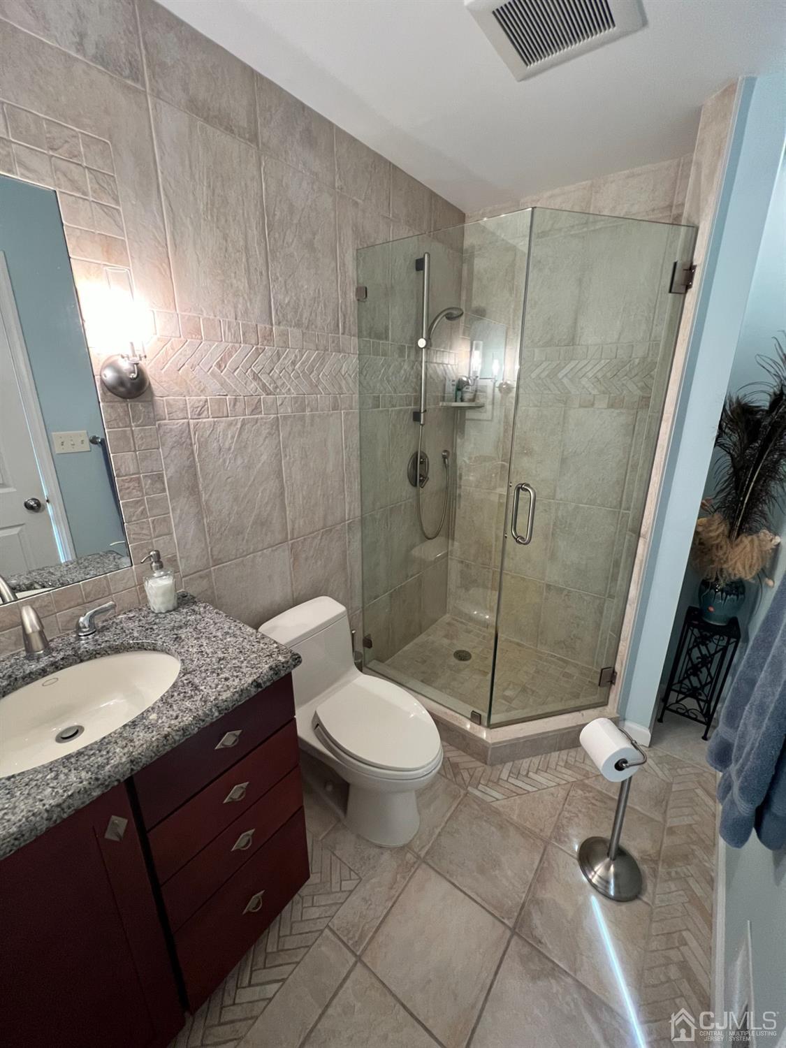 55 Winton Road East Brunswick, NJ 08816 - Photo 25 of 39 a bathroom with a granite countertop sink toilet mirror and shower