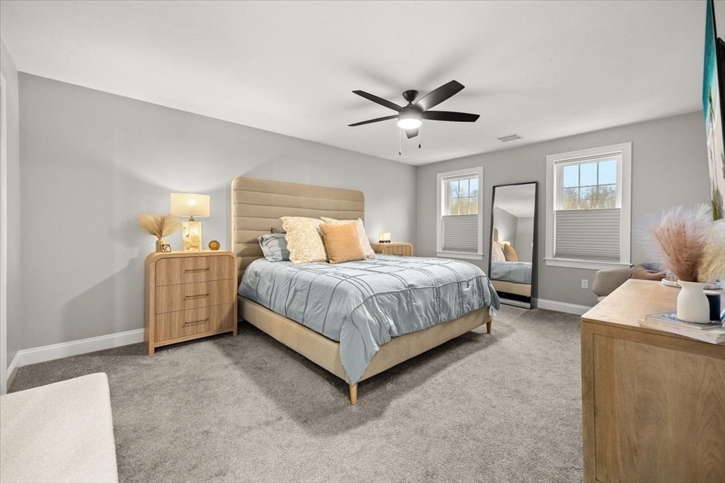 70 Sandy Hill Road Raynham, MA 02767 - Photo 19 of 42 a bedroom with a bed and a chandelier