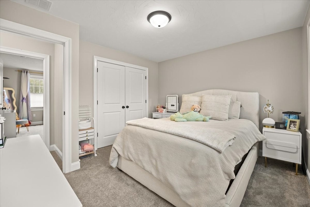 70 Sandy Hill Road Raynham, MA 02767 - Photo 24 of 42 a bedroom with a bed and a mirror