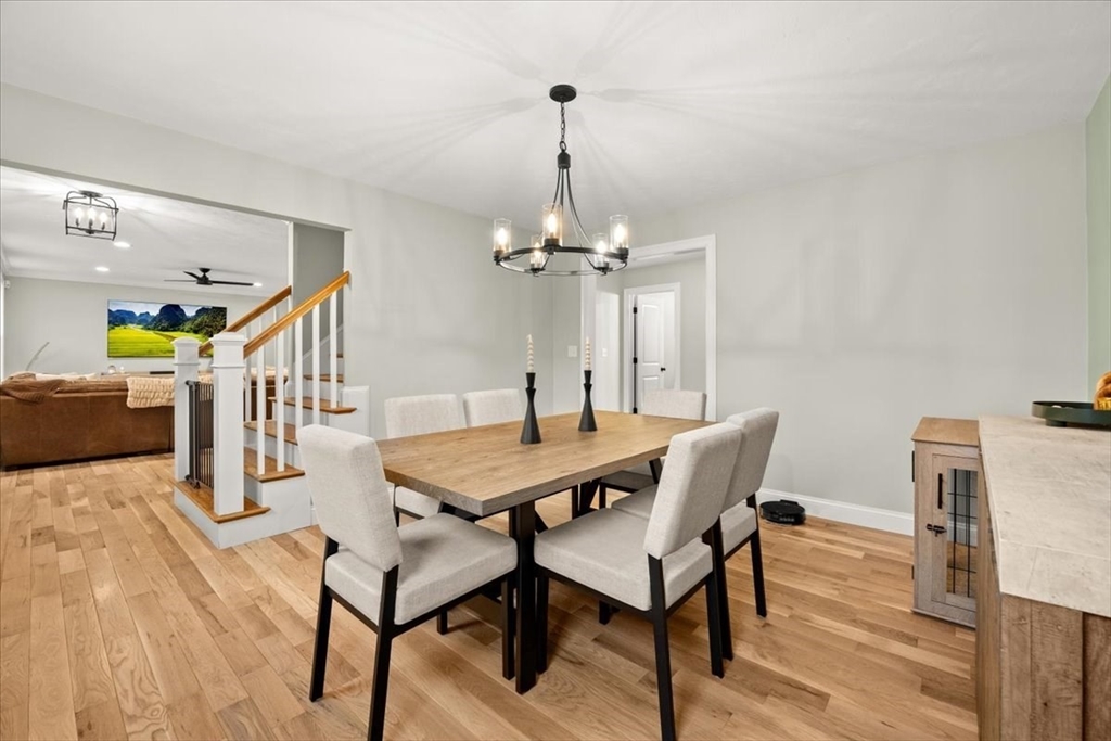 70 Sandy Hill Road Raynham, MA 02767 - Photo 9 of 42 a dining room with furniture a chandelier and wooden floor