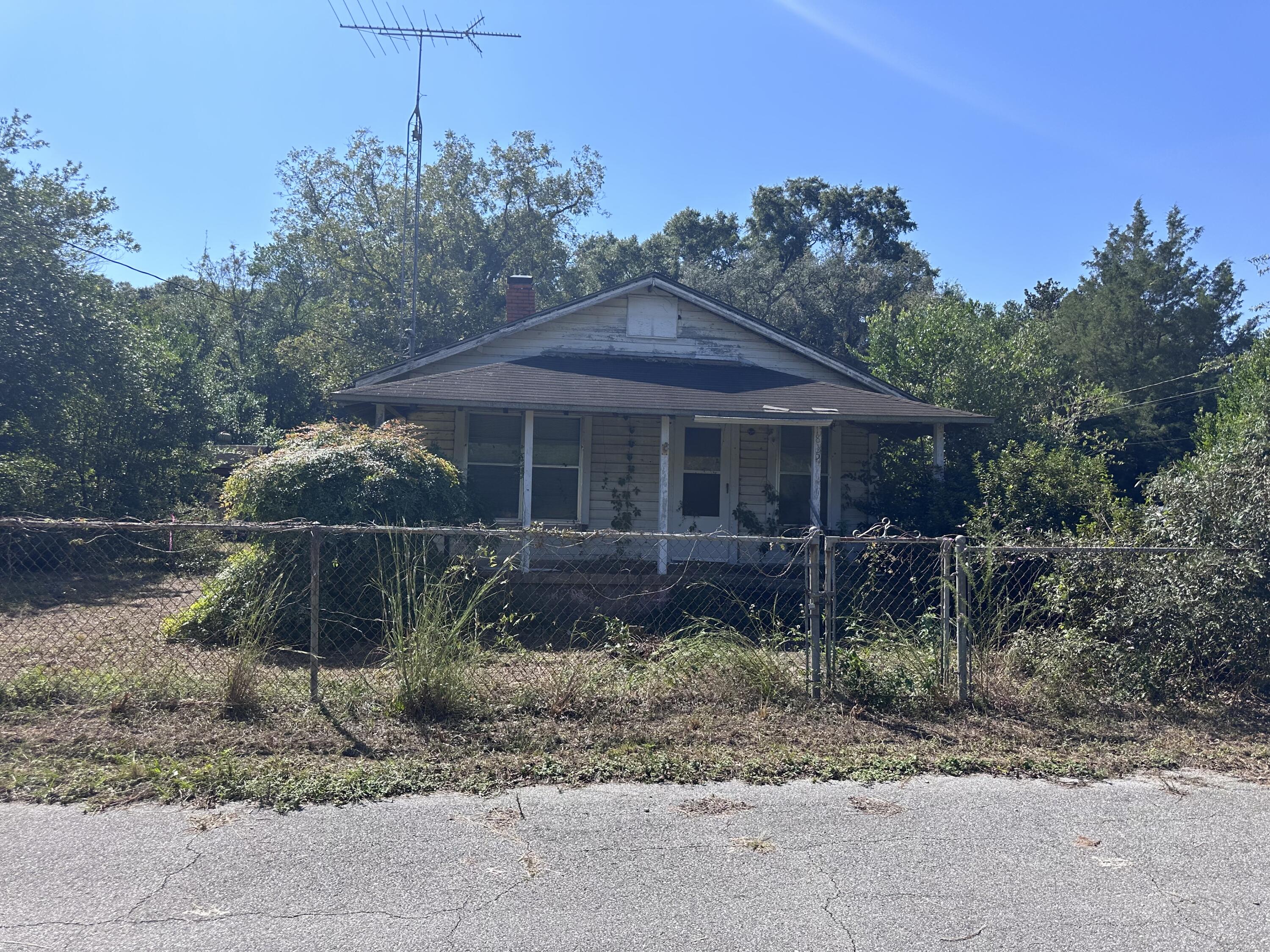 1815 Wadsworth Road Baker, FL 32531 - Photo 1 of 6 a front view of a house with a garden